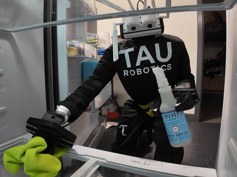 Humanoid unit cleaning inside a refrigerator with cloth and spray